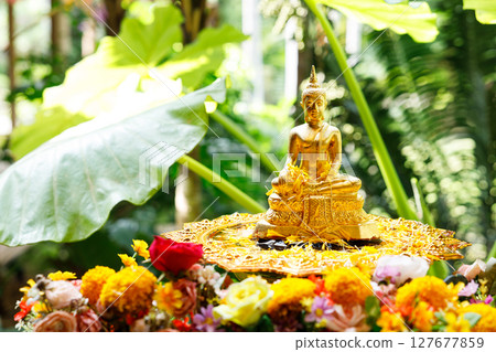 Buddha image and flowers. Preparation for Water Festival in Thailand. 127677859