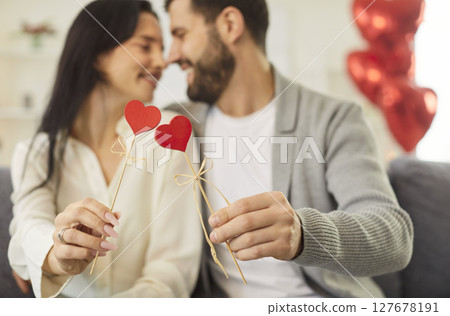 Close-Up Of Couple Holding Red Hearts, Kissing And Celebrating Valentine's Day Close-Up Of Couple Holding Red Hearts, Kissing And Celebrating Valentine's Day 127678191