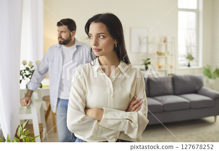 Angry displeased disappointed young woman is having a conflict with her husband  127678252