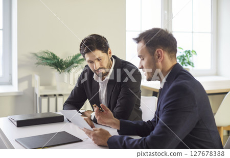 Serious lawyer, solicitor or barrister, supervisor talk to analyse financial report, professional insurance Serious lawyer, solicitor or barrister, supervisor talk to analyse financial report, professional insurance 127678388