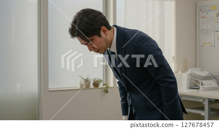 Apologizing businessman man 127678457