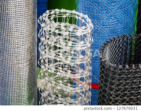 Various types of mesh rolls displayed in a hardware store during daylight hours Various types of mesh rolls displayed in a hardware store during daylight hours 127679031