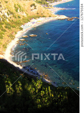 Vertical background with breathtaking panoramic view of the sparkling sea along the southern coast of Italy in Calabria. This stunning landscape captures the vivid blue waters meeting the rugged Vertical background with breathtaking panoramic view of the sparkling sea along the southern coast of Italy in Calabria. This stunning landscape captures the vivid blue waters meeting the rugged 127679384