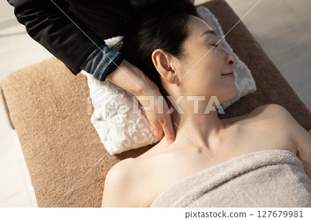 Woman receiving a head massage 127679981