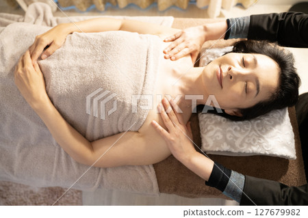 Woman receiving massage treatment 127679982