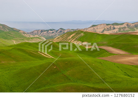 Serene rolling hills and farmland in rural mountainous region Serene rolling hills and farmland in rural mountainous region 127680152