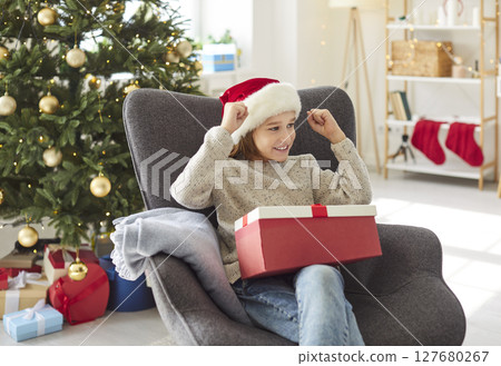 Surprised Boy Celebrating Christmas Or New Year With A Gift At Home 127680267