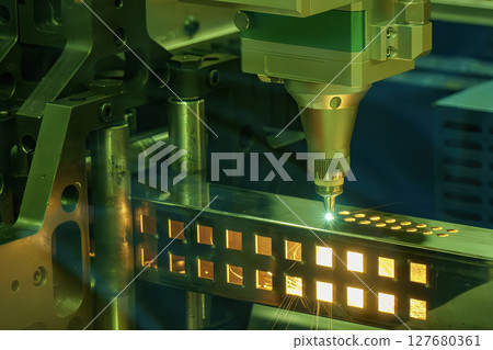 Close up scene the fiber laser cutting machine cut the square shape stainless steel tube with sparkling light. 127680361