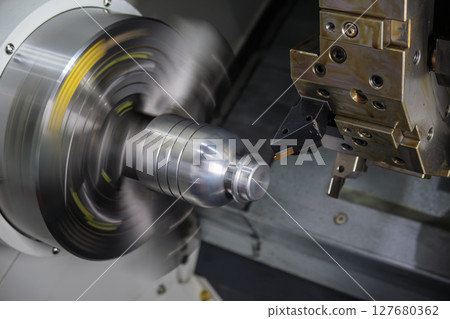 Close up scene the CNC lathe machine groove cutting the metal shaft parts. 127680362