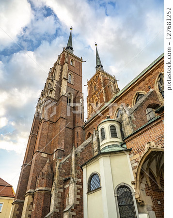 Historic Brick Collegiate Church of the Holy Cross, St Bartholomew With Twin Towers Against a Cloudy Sky 127681252