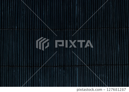 Black Bamboo Mat on Dark Background Tied Up With the Rope 127681287