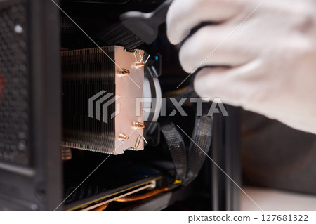 Cleaning a processor fan with a brush 127681322