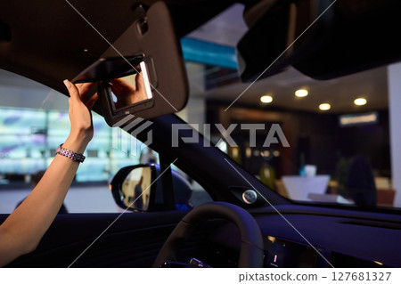 The modern car interior features a sleek vanity mirror that highlights both functionality and style 127681327