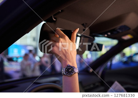 The modern car interior features a sleek vanity mirror that highlights both functionality and style 127681330