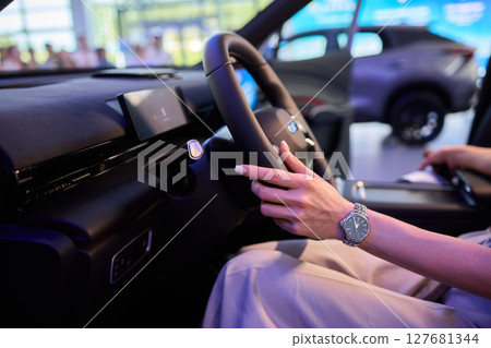 This modern car interior showcases a stylish and luxurious steering wheel and design 127681344