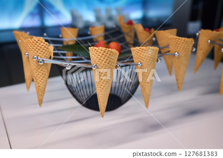 Elegant and Beautiful Dessert Presentation Featuring Ice Cream Cones Alongside Fresh Strawberries 127681383