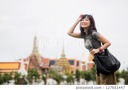 Happy solo Southeast Asian woman teenage blogger and world travel explorer enjoys local cultural tourism experience in Bangkok Thailand. concept for travel in Asia Happy solo Southeast Asian woman teenage blogger and world travel explorer enjoys local cultural tourism experience in Bangkok Thailand. concept for travel in Asia 127681447