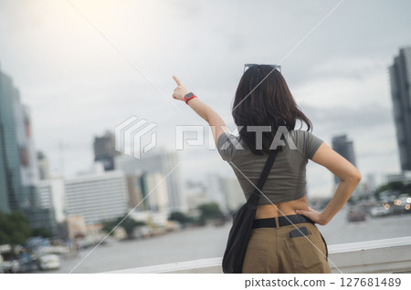 Solo tourism concept young southeast asian woman and teenager blogger. World travel explorer has local cultural experience with smartphone over Chao Phraya river in Bangkok Asia Thailand 127681489