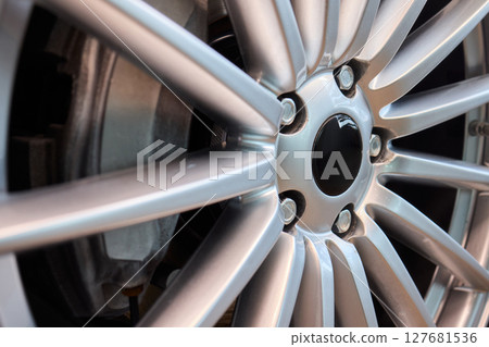 An Up Close View of a Stylish and Contemporary Car Wheel Featuring a Sporty Caliper An Up Close View of a Stylish and Contemporary Car Wheel Featuring a Sporty Caliper 127681536