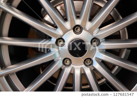 Detailed shot of a sleek black and silver alloy wheel on a motor vehicle 127681547