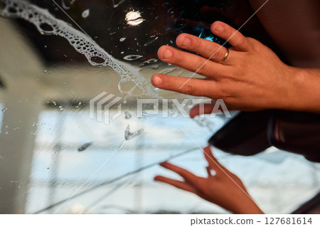 The Professional Windshield Tinting Process Conducted in a Modern Auto Showroom Environment 127681614