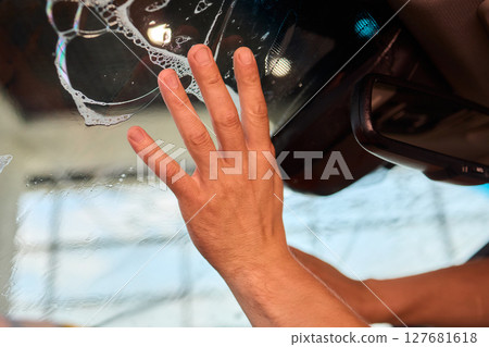 The Professional Windshield Tinting Process Conducted in a Modern Auto Showroom Environment 127681618