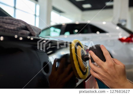 A Detailed Close Up of the Car Polishing Process in the Field of Automotive Detailing A Detailed Close Up of the Car Polishing Process in the Field of Automotive Detailing 127681627