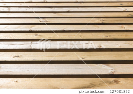 Parallel wooden slats in a natural rustic finish 127681852