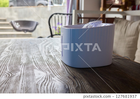A Playful Ginger Cat at a Water Fountain Captivates with Its Adorable and Curious Nature 127681937
