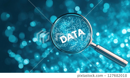 Conceptual image of a magnifying glass revealing DATA over data analytics, representing leadership  127682018
