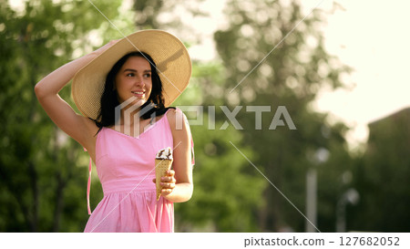Styled and sweet. Woman in pink dress enjoying ice cream outdoors on sunny day 127682052