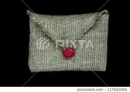 Canvas envelope sealed with red wax and isolated on black background 127682068