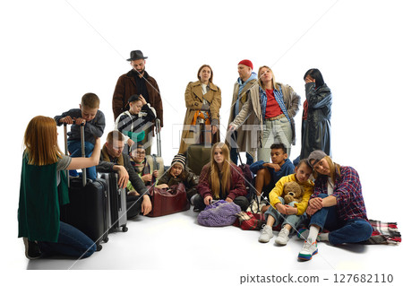 Group of diverse people with luggage embodying themes of migration and human rights struggle 127682110