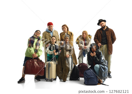 Diverse group of travelers with luggage symbolizing global migration and economic hardship Diverse group of travelers with luggage symbolizing global migration and economic hardship 127682121