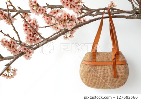 Handbag hangs From a Flowering branch For Spring Fashion Concept 127682560