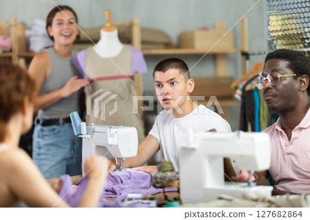 Participants in coterie practice sewing, chatting and talking, work with mannequin 127682864