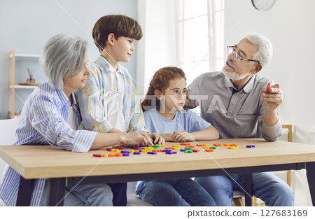 Happy Grandchildren And Grandparents Learning Letters Together At Home 127683169