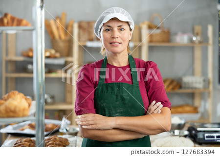 Adult female baker posing in workshop Adult female baker posing in workshop 127683394