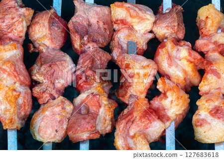 Barrel Used for Grilling Beef,. Lots of white smoke with a delicious aroma is coming out of the barrel hole. 127683618