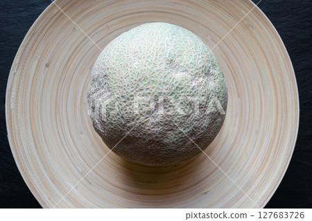 Hami Melon Fruit on Bamboo Plate 127683726