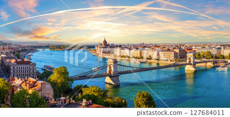 Chain bridge over Danube River in Budapest at sunset, with Parliament and Margaret Island, beautiful panorama of Hungary Chain bridge over Danube River in Budapest at sunset, with Parliament and Margaret Island, beautiful panorama of Hungary 127684011