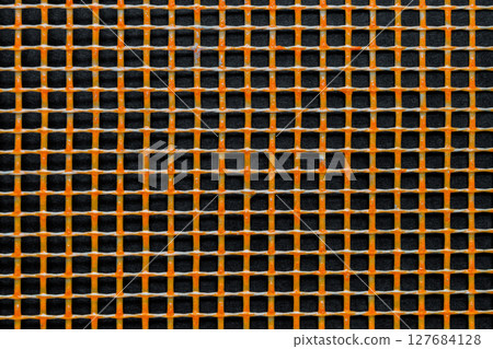 Orange Plastic Grid on Black Background Surface 127684128