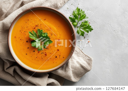 Top View of Lentil Soup with Parsley Garnish on Light Gray Background 127684147