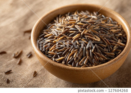 Bowl of Wild Rice with Natural Shadows on Earthy Background 127684268