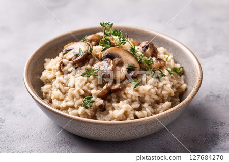 Vegan Mushroom Risotto with Fresh Thyme on Neutral Background 127684270
