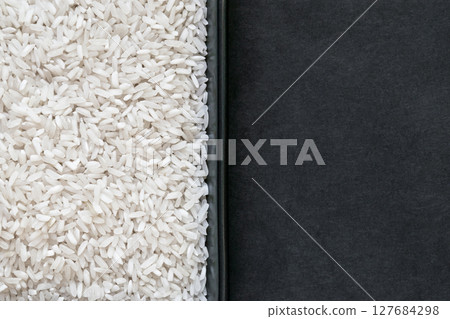 Rice Grains in the Plate and Black Background With Free Space Rice Grains in the Plate and Black Background With Free Space 127684298