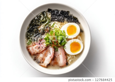 Top-Down View of Ramen Bowl with Egg, Seaweed, and Pork on White Background 127684425
