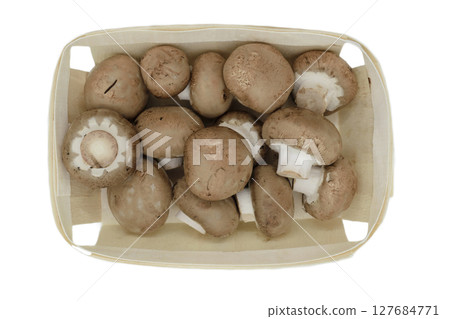 Top view of brown champignons mushrooms placed in wooden basket and isolated on white background Top view of brown champignons mushrooms placed in wooden basket and isolated on white background 127684771