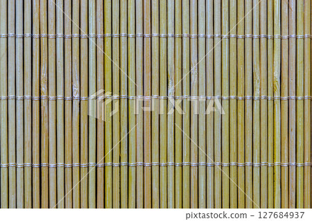 Yellow Bamboo Mat on Black Background Surface Yellow Bamboo Mat on Black Background Surface 127684937