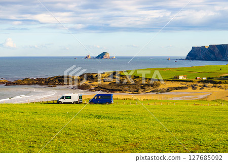 Camper vans on Verdicio beach, Asturias coast in Spain. 127685092